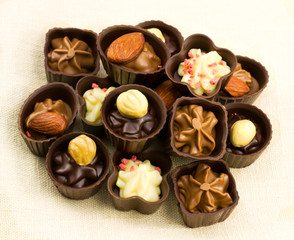 chocolate candy with nuts on a napkin of burlap