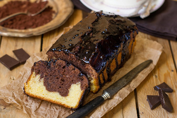 Fototapeta na wymiar Chocolate loaf marble cake with chocolate glazing