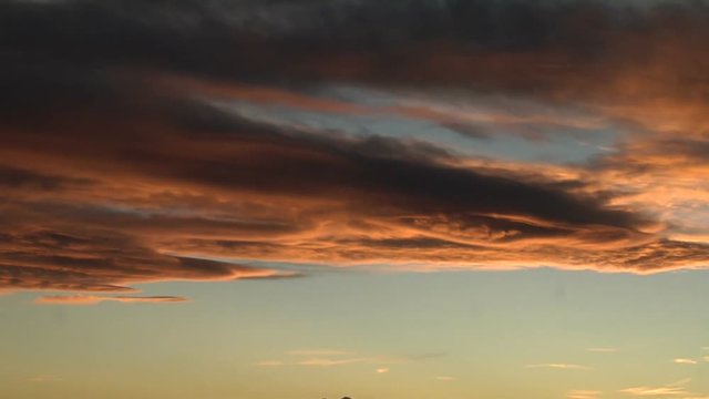 Luminous Lenticular Wave Clouds at Sunset