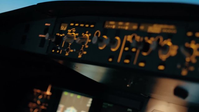 Close shot of aircraft cabin or cockpit. Camera panorama from flight deck center panel to glareshield with auto pilot controls. Interior of Airbus A319 A320 A321 shot at training centre