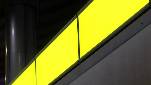 Empty signboard hanging in building. Blank sign with yellow light. 