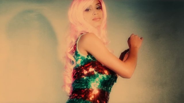 beautiful sexy female dancer in amazing glittering costume in disco setting