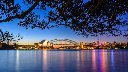 mirrored Sydney Skyline in the water after sunset , Australia