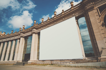 Empty huge mock up banner for your advertising on facade of building, blank giant billboard with...