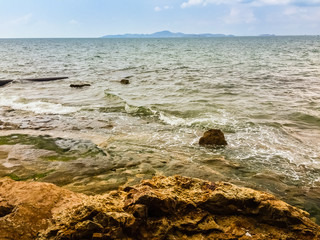 Clear Pattaya Sea water with Koh Larn and blue sky in background