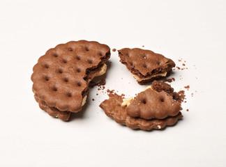 Tasty cookie with crumbs on white background