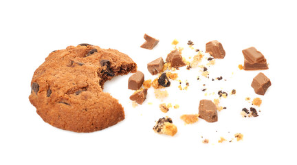 Tasty cookie with chocolate chips and crumbs on white background