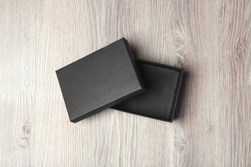 Black empty box on wooden background