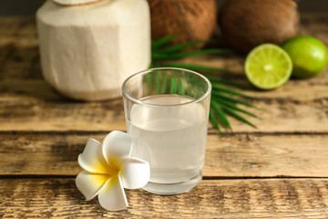 Coconut water in glass on wooden table