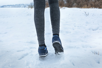 Legs of running woman outdoors on winter day