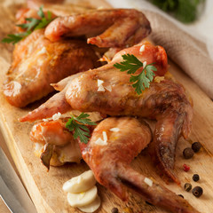 Grilled chicken wings on board. Food concept.