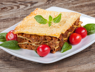 tasty lasagna isolated on the old board