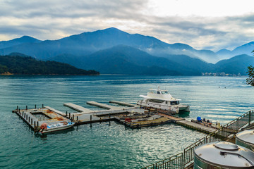 Beautiful Landscape of Sun Moon Lake in the morning with blue mountain background. Tourist likes to visit the beautiful attractions around the sun moon lake by boat cruise