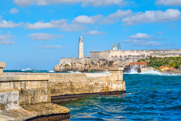 Fototapeta na wymiar The fortress and lighthouse of El Morro and the Malecon seawall