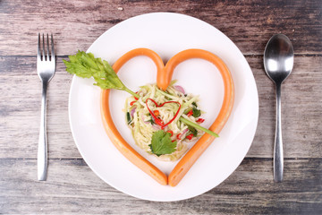 Sausage cheese in heart style with spicy green mango salad.