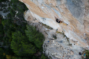 Rock climber, professional athlete, climbing in Siurana rocks, Spain. Extreme sports. 