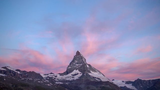 dawn, sunrise time lapse of the amazing matterhorn mountain in the Swiss Alps. the sky lights up in an incredible display of colour followed by the shadow lowering over the mountain