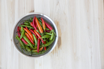 bunch of chili peppers on wood table