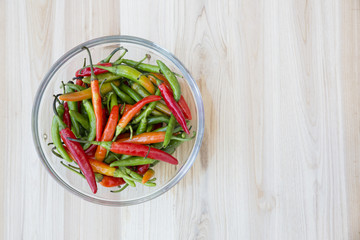 bunch of chili peppers on wood table