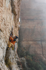 Rock climber, professional athlete, climbing in Siurana rocks, Spain. Extreme sports. 