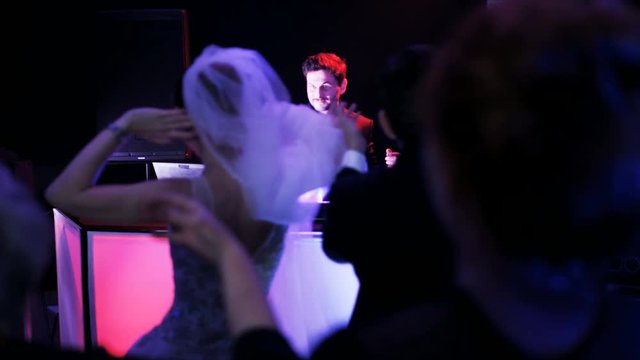 The Young Couple Dancing Macarena in a Nightclub