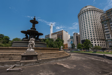 Fototapeta na wymiar Empty Fountain at the Mahatma Gandhi Square and View of Office Buildings of Rio de Janeiro under the Clear Blue Sky