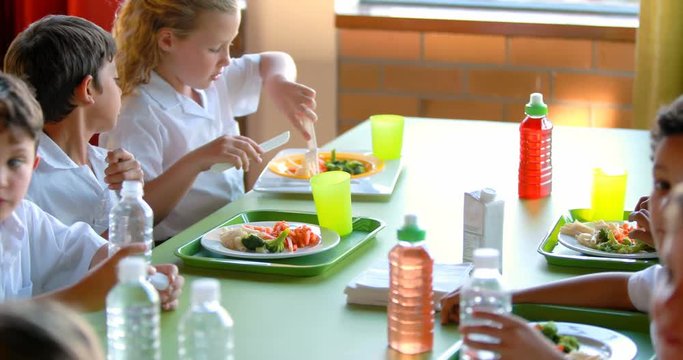 Kids having meal in school cafeteria 4k