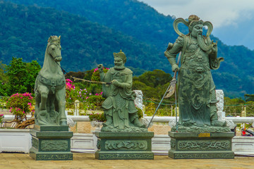 Detailed Chinese design with Gods statues in gold including walls sculptures of dragons and horses...