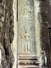 Stone carving of an angel or Apsara on the wall of Angkor Wat, the 12th century Hindu temple complex in Cambodia