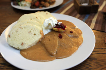 Goulash served with bread dumplings and lemon