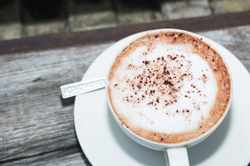 hot coffe on coffee cup on wood table
