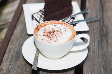 hot coffe on coffee cup on wood table
