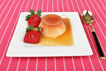Creme caramel dessert with strawberries