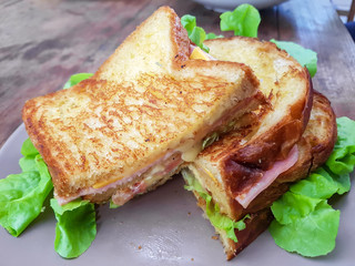 Sliced grilled sandwiches bread with bacon , ham, cheese and veg