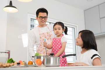 asian family cooking at kitchen