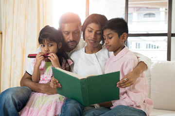 indian family reading a book together