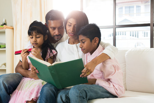 Indian Family Reading A Book Together