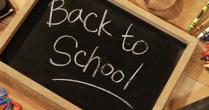 Close-up of chalkboard with colored pencil and crayon on a table 4k
