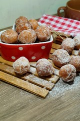 Sweet donuts in a dish in the shape of heart. Fat Thursday Slavic culture 

