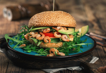Burger with grilled prawns on the plate