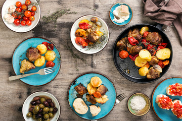 Dinner table with many different meals, top view