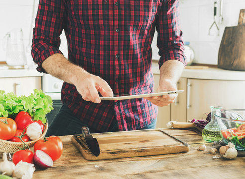 Man following recipe healthy food in kitchen at home