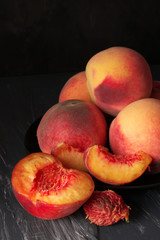 Fototapeta na wymiar Peaches on black close-up