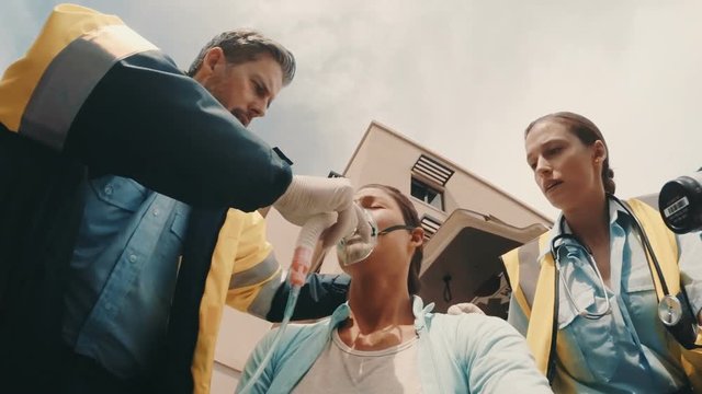 Doctor putting an oxygen mask on patient