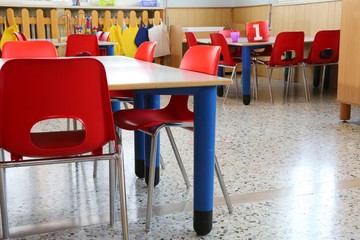 red chairs with small benches inside a kindergarten for children