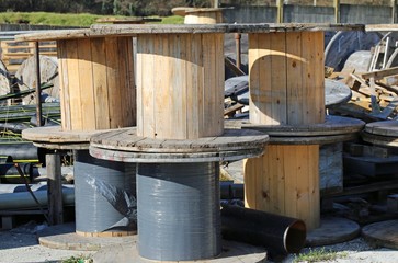 many wooden reels for electrical cables in landfills