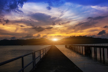 Fototapeta na wymiar Landscape of bridge in the port between sunset silhouettes