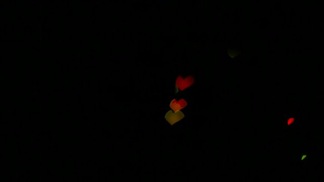 Illumination garland decoration blinking on heart shaped bokeh background.
