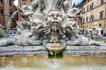 Fototapeta na wymiar In the center of the piazza is a fountain, the Fontana del Pantheon, surmounted by an Egyptian obelisk. The fountain was constructed by Giacomo Della Porta under Pope Gregory XIII in 1575
