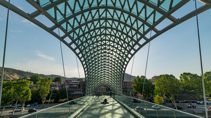 Tbilisi, Georgia - August 6, 2015:  Bridge of Peace in Tbilisi, Georgia, bow-shaped pedestrian bridge over the Kura River in Tbilisi, capital of Georgia. © CanYalicn